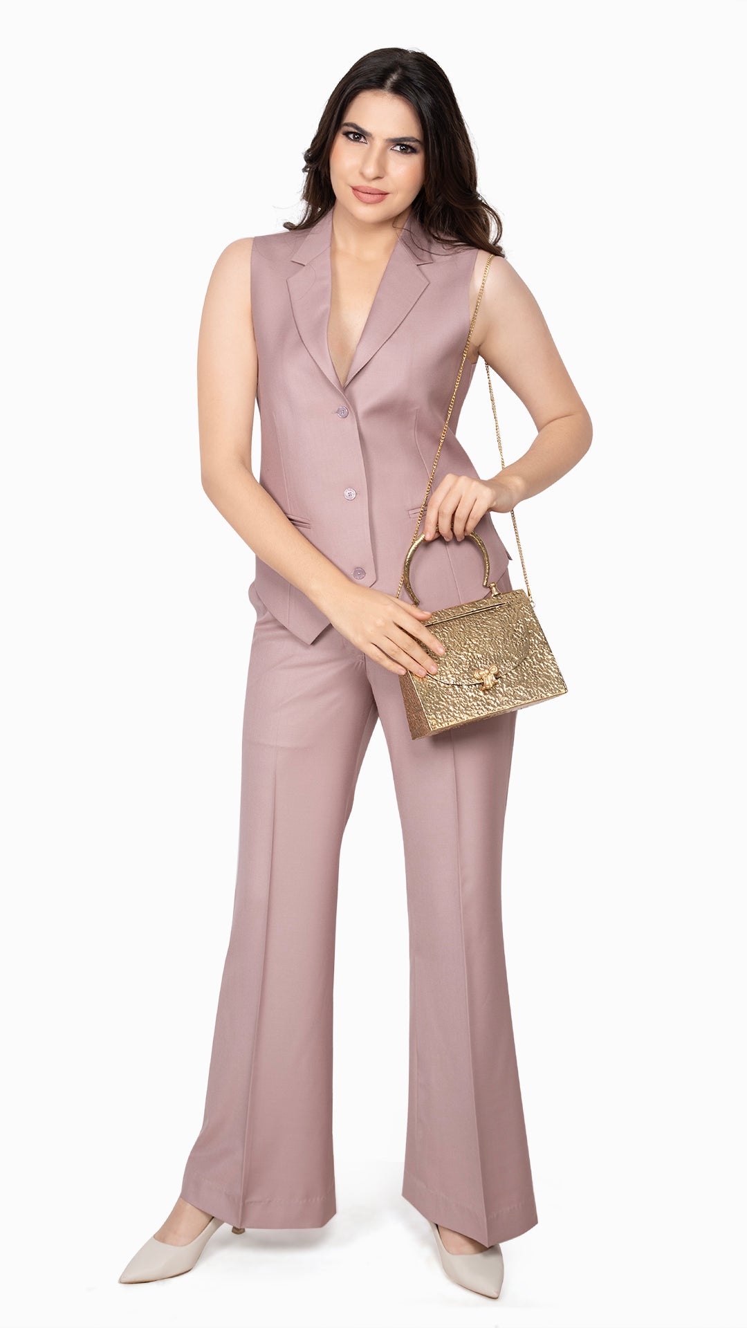 A modern waistcoat-and-trouser set in soft onion pink, designed for a bold yet refined look with vintage-inspired flared pants.