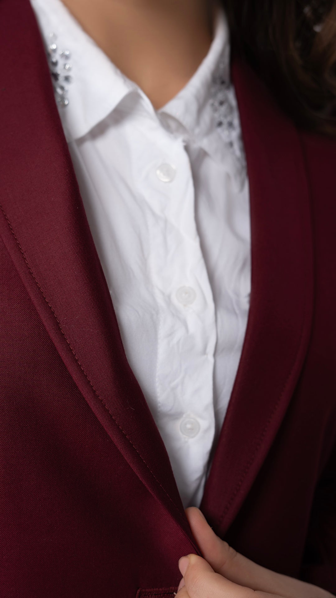 A detailed view of the blazer’s patch pockets, emphasizing the balance of structure and ease in this modern piece.