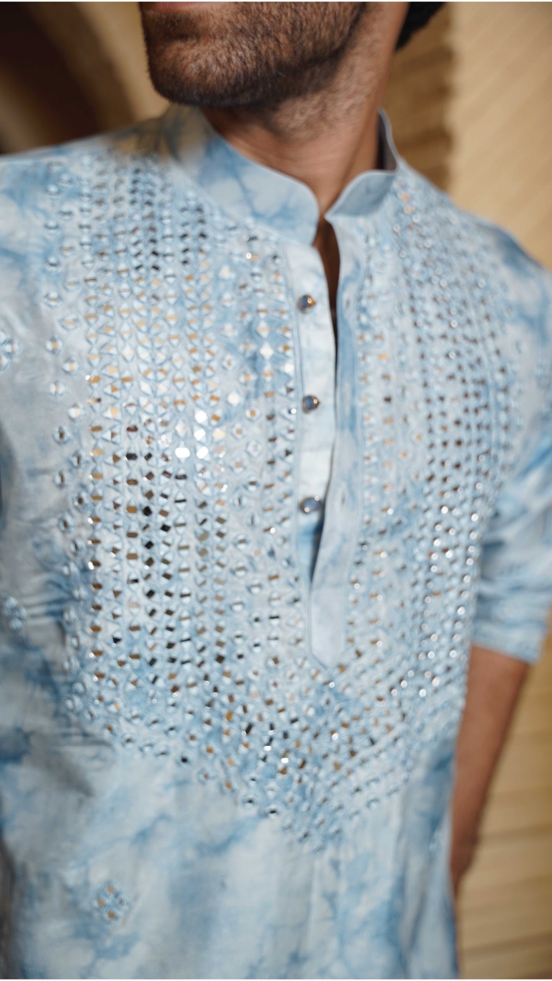 Close up tye-dye blue embroidered kurta with a blurred background