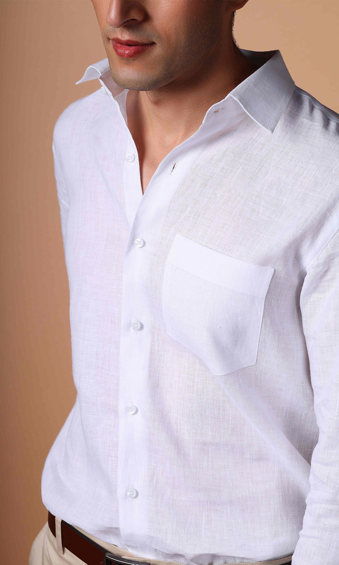 Detailed view of a white linen shirt on a model, emphasizing the classic and sophisticated design