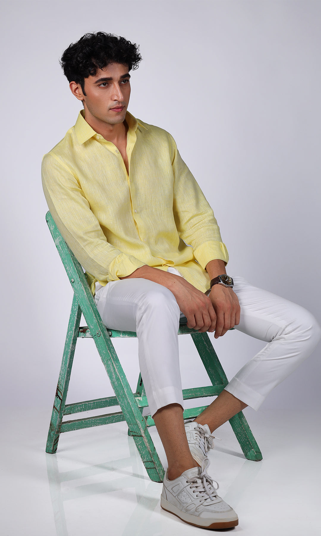Front view of a yellow linen shirt on a model, displaying a sharp and attractive look.