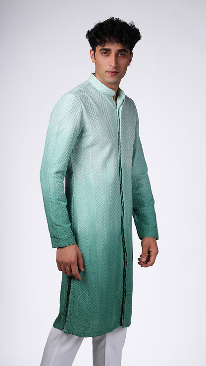 Close-up of Green Ombre Kurta with Bamboo Embroidery, highlighting intricate details. Model paired with white slim trousers