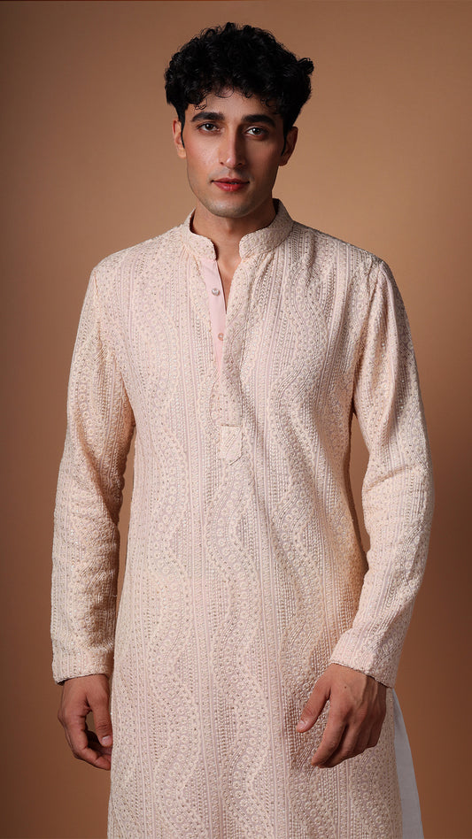 Detailed view of Peach Kurta, highlighting dense sequin and mirror patterns. Model styled with salwar.