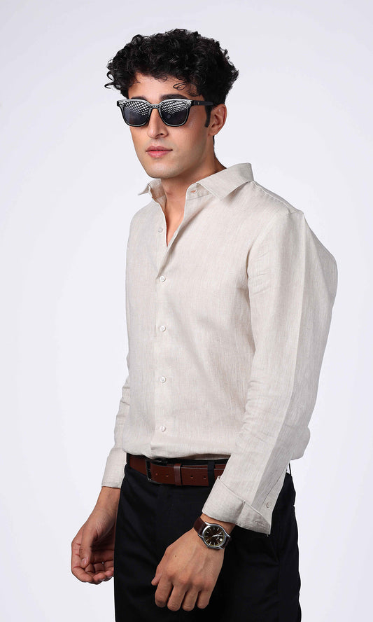 Model posing in a beige linen shirt, sleeves rolled up for a relaxed fit.