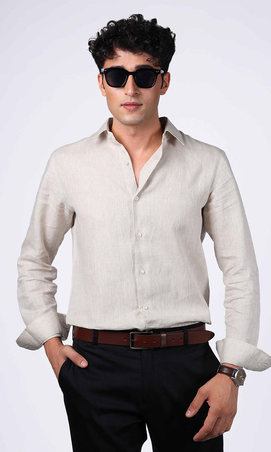 Front view of a beige linen shirt on a model, styled with a clean and smart look.