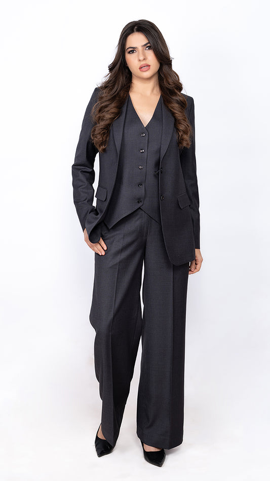 Impeccably tailored dark grey suit for women, including a blazer, waistcoat, and trousers. A modern take on classic formal wear.