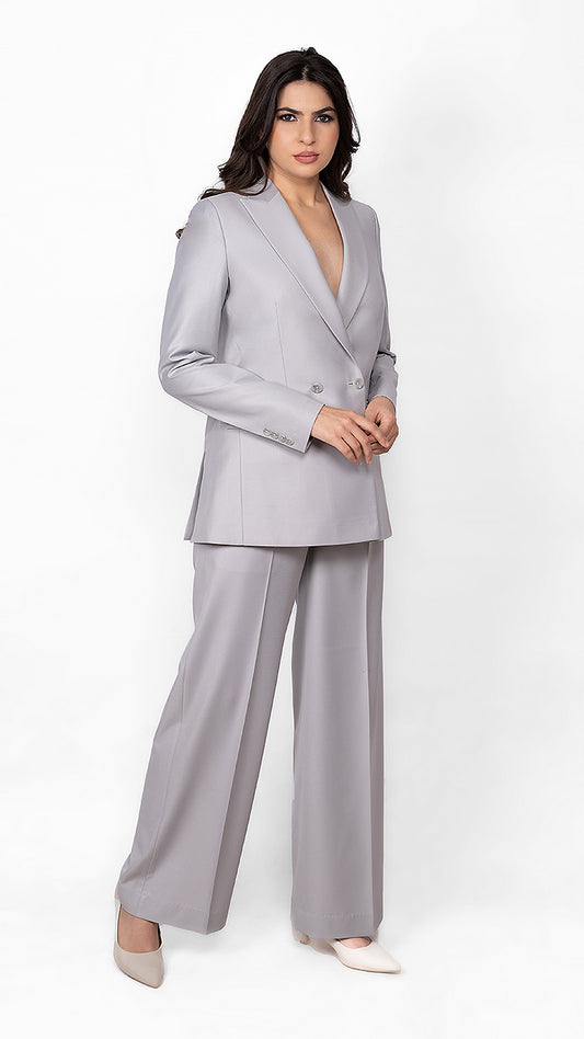 A soft yet bold light grey suit featuring a precisely tailored blazer and trousers, ideal for a strong yet feminine aesthetic.