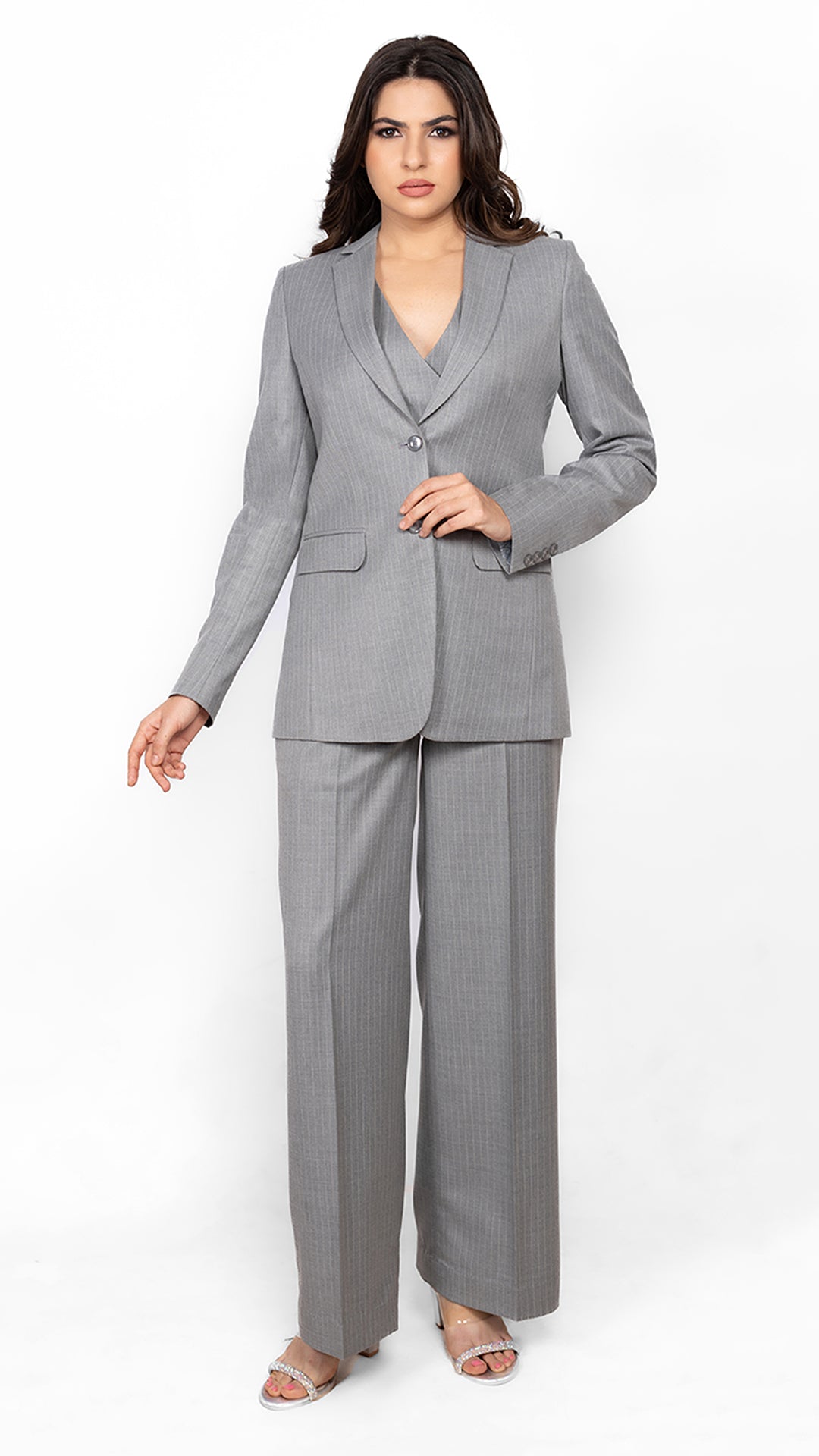 Designed for bold, confident women, this pinstripe three-piece suit in grey offers timeless elegance with structured tailoring and a sharp silhouette.