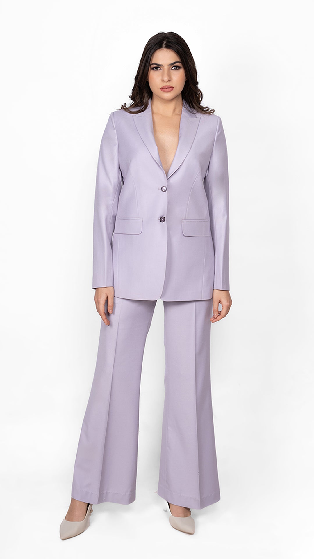 A feminine yet bold lavender suit featuring a precisely tailored blazer and trousers, embodying effortless confidence and style.

