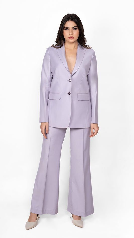 A feminine yet bold lavender suit featuring a precisely tailored blazer and trousers, embodying effortless confidence and style.

