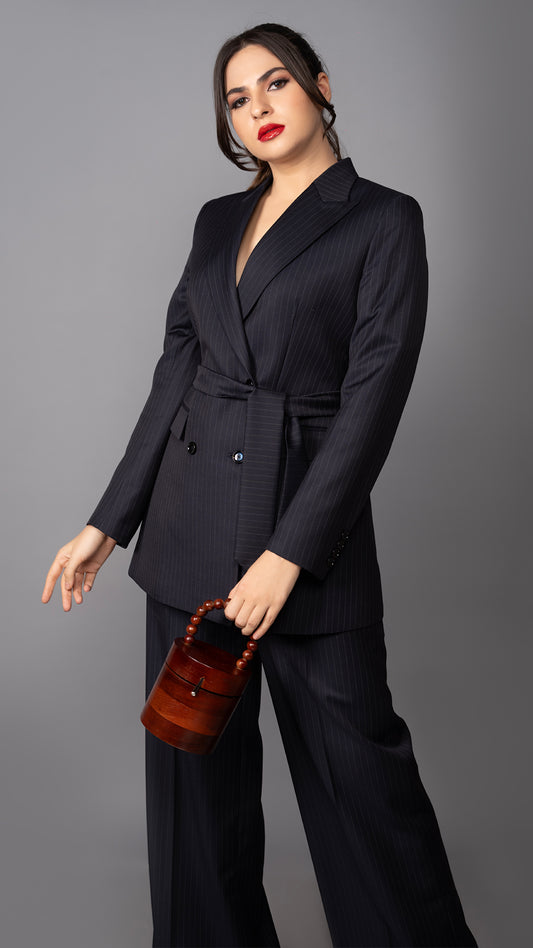 A contemporary take on a classic pinstriped suit, featuring a belted blazer and tailored trousers for a polished, high-fashion look.

