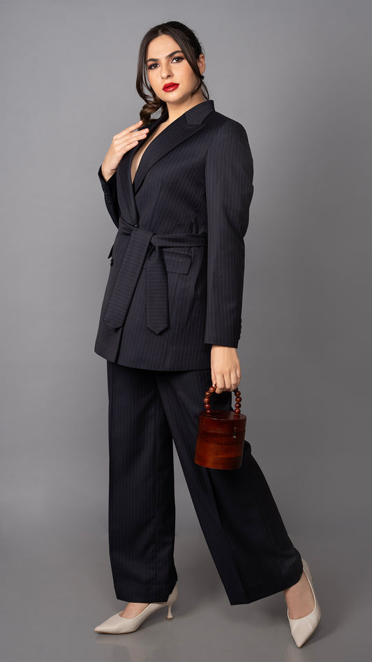 A modern two-piece suit in deep blue pinstripes, featuring a belted blazer and slim-fit trousers for a refined, elegant aesthetic.