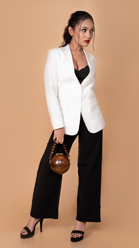 A refined white blazer paired with black denims, striking the perfect balance between formal sophistication and relaxed elegance.