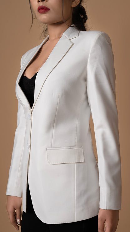 A close-up of the sleeve and button accents, showcasing the refined craftsmanship of the white blazer.