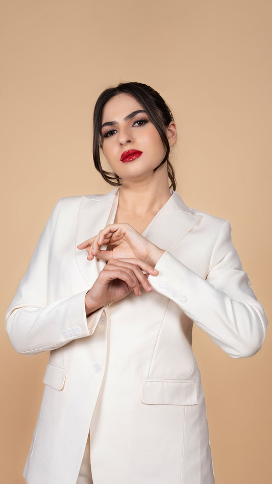 A minimalist yet powerful off-white blazer with a tailored silhouette, peak lapels, and a refined finish. Perfect for modern professionals.
