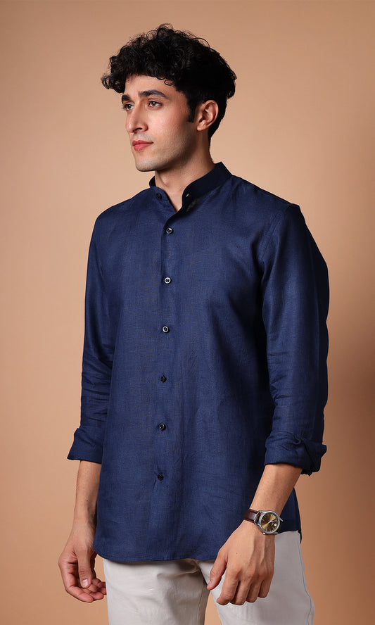 Model posing in a navy blue linen shirt, depicting a strong and assertive look.