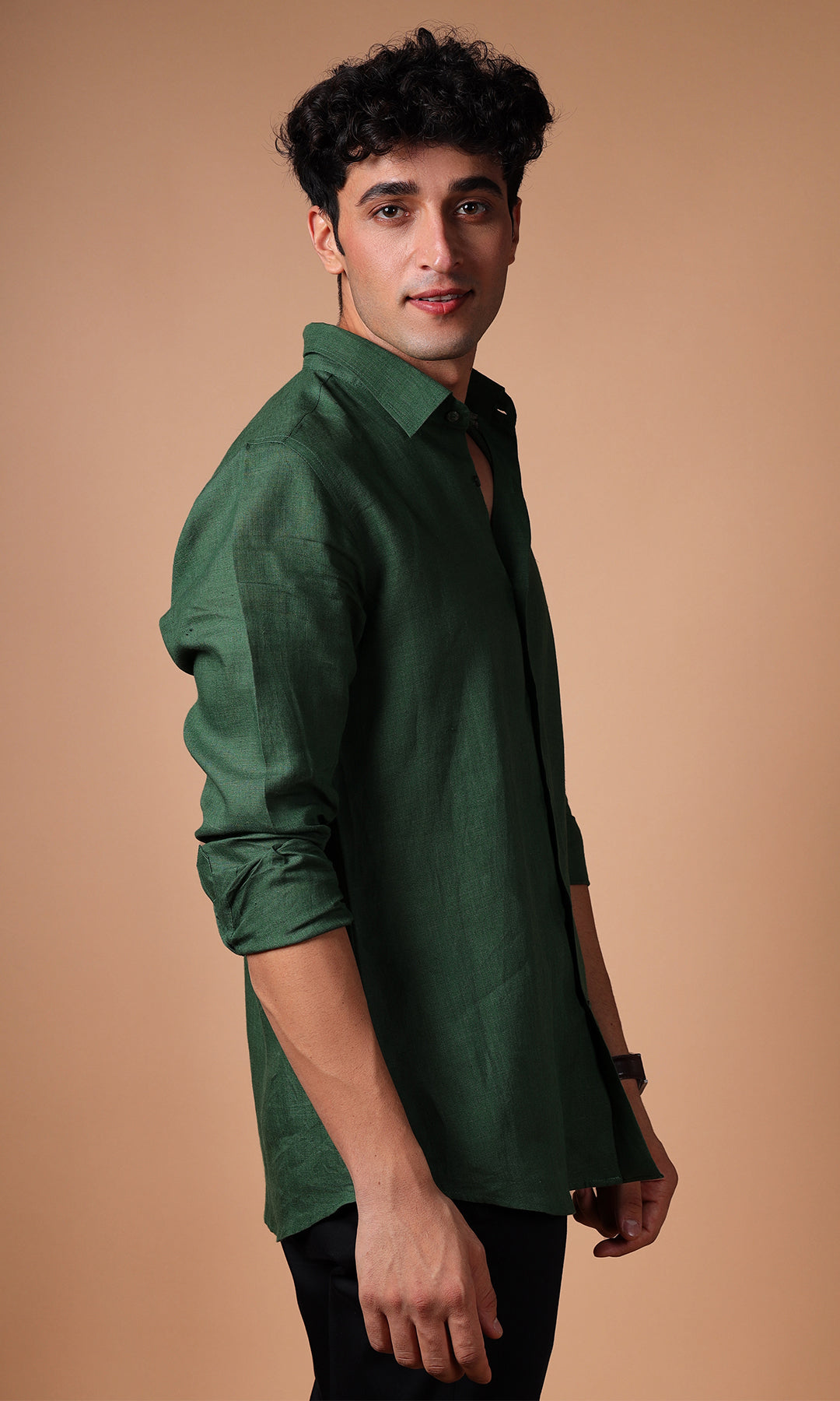 Side profile of a model wearing an olive green linen shirt, emphasizing the casual yet stylish fit.