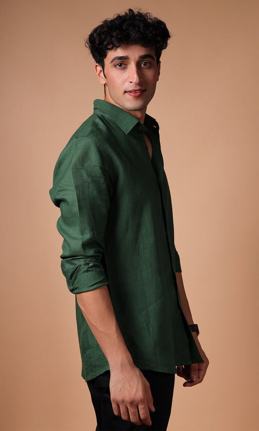 Side profile of a model wearing an olive green linen shirt, emphasizing the casual yet stylish fit.
