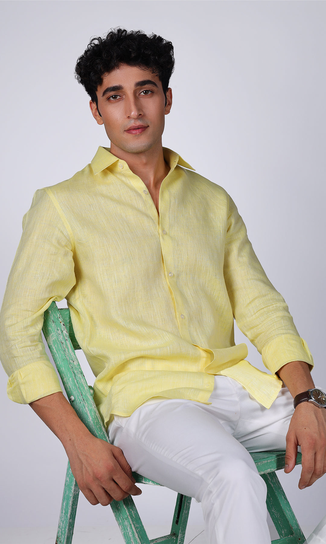 Model showcasing a vibrant yellow linen shirt, close-up on the bright color and smooth texture