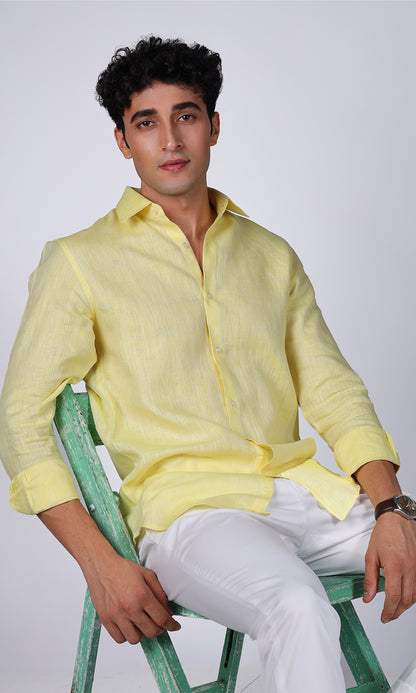 Model showcasing a vibrant yellow linen shirt, close-up on the bright color and smooth texture