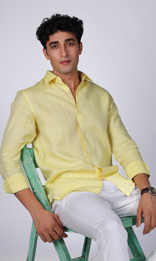 Model showcasing a vibrant yellow linen shirt, close-up on the bright color and smooth texture