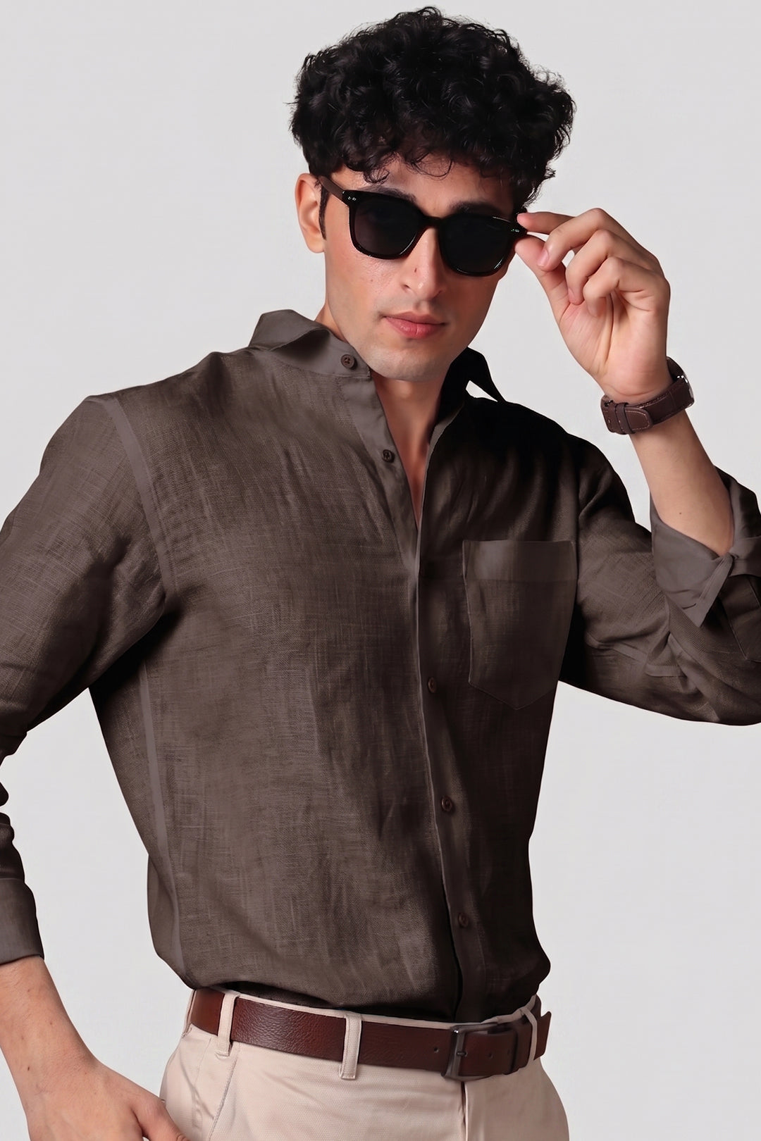 Bison Brown pure linen shirt for men, styled with sunglasses and brown leather belt, spread collar worn open, chest pocket detail, paired with beige trousers, by BWO