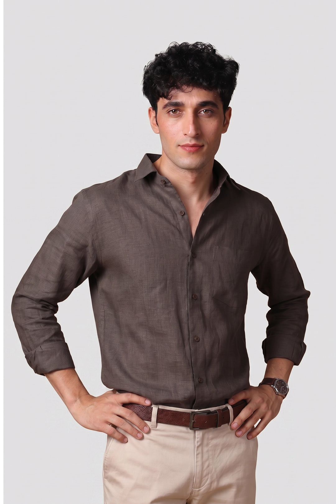 Bison Brown pure linen shirt for men, front view with sleeves rolled up, classic spread collar and chest pocket, styled with beige trousers and brown leather belt, by BWO