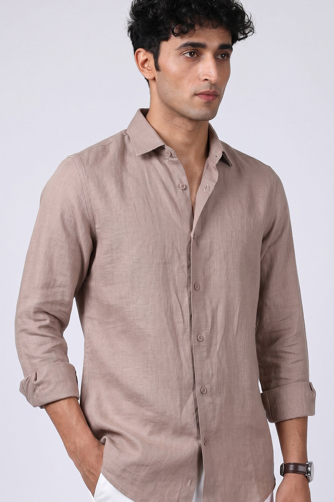 Greige pure linen shirt for men, side angle view with collar open and sleeves rolled, full button placket and linen texture visible, styled with white trousers, by BWO
