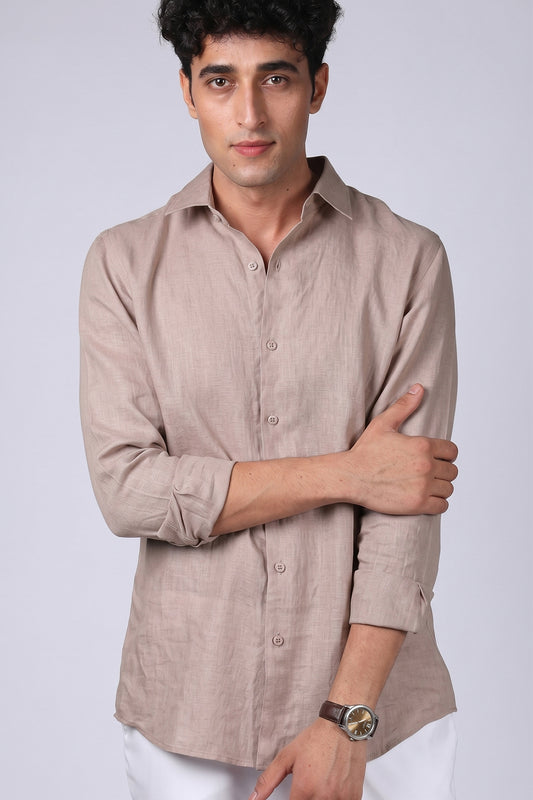 Greige pure linen shirt for men, front view with arms crossed and sleeves rolled, classic spread collar and full button placket, styled with white trousers, by BWO