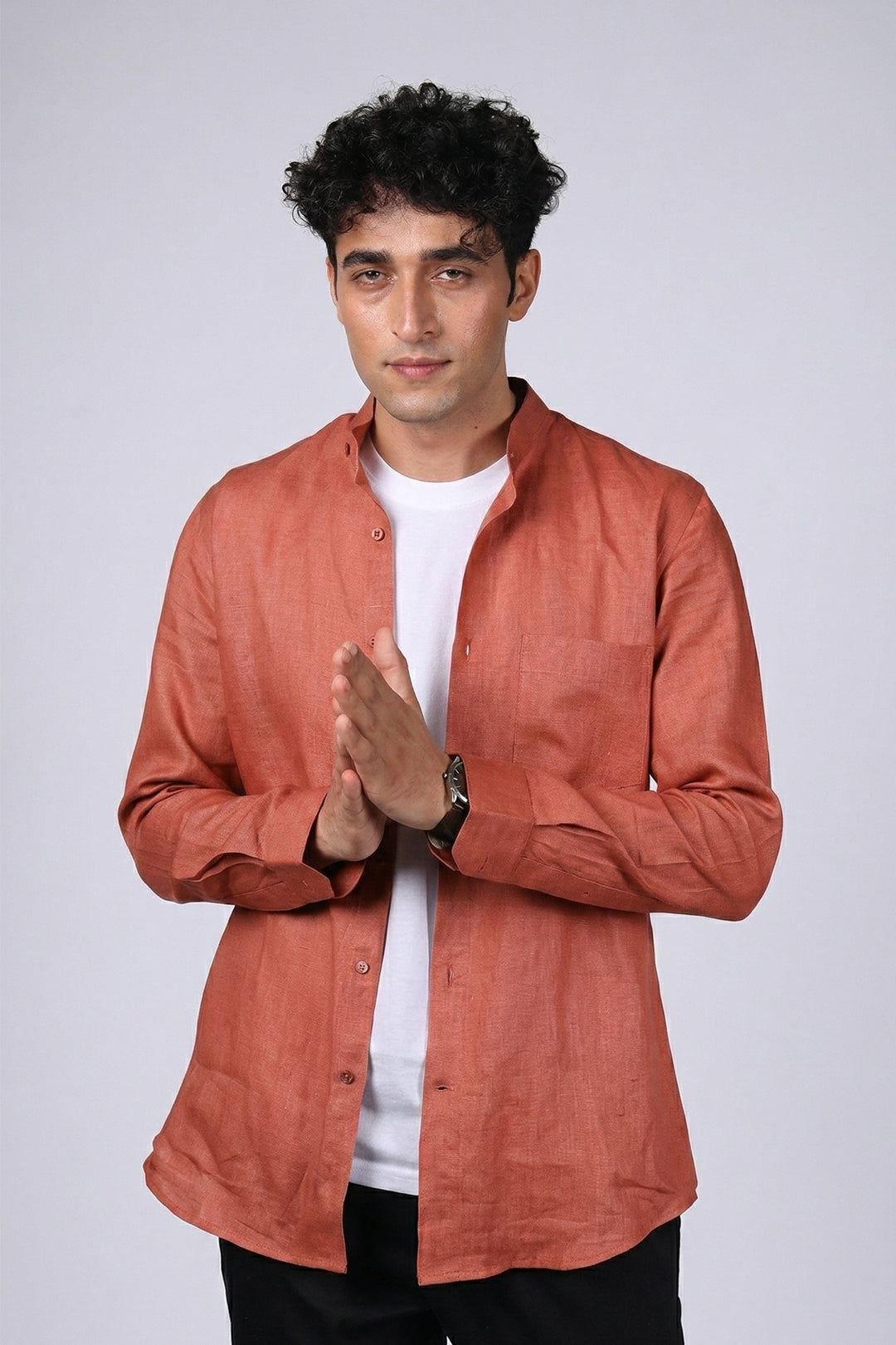 Rust pure linen shirt for men, front view worn open over white tee, band collar with chest pocket, long sleeves, styled with black trousers, by BWO