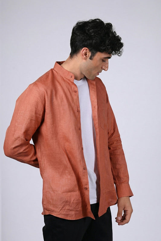 Rust pure linen shirt for men, side view worn open over white tee, band collar and long sleeves with buttoned cuffs, styled with black trousers, by BWO