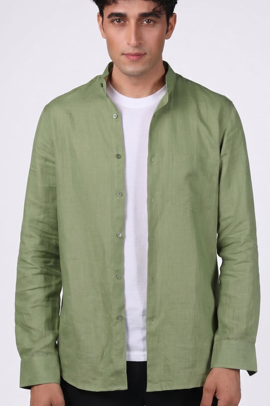 Sage green pure linen shirt for men, front view worn open over white tee, band collar and chest pocket visible, full button placket, styled with black trousers, by BWO