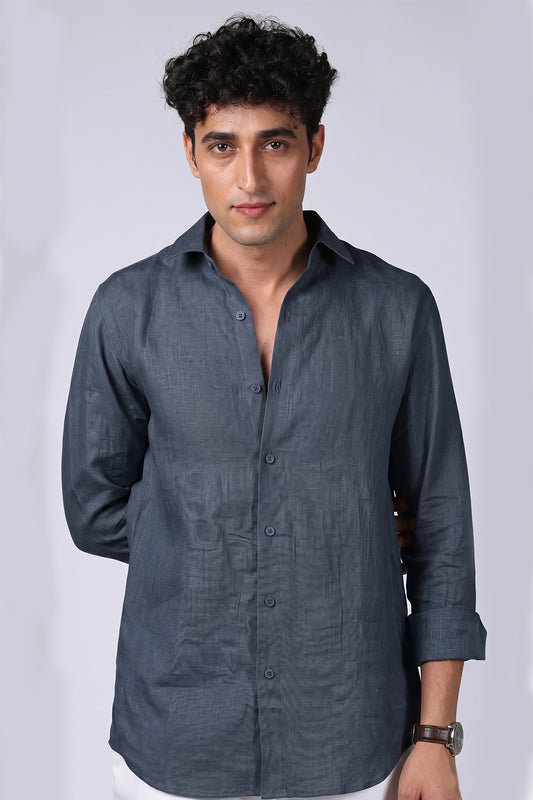 Steel blue pure linen shirt for men, full front view with collar open and sleeves rolled, classic spread collar and rounded hem, styled with white trousers, by BWO