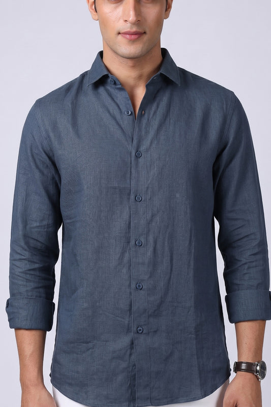 Steel blue pure linen shirt for men, close-up of spread collar, full button placket and end-on-end linen texture, sleeves rolled, styled with white trousers, by BWO